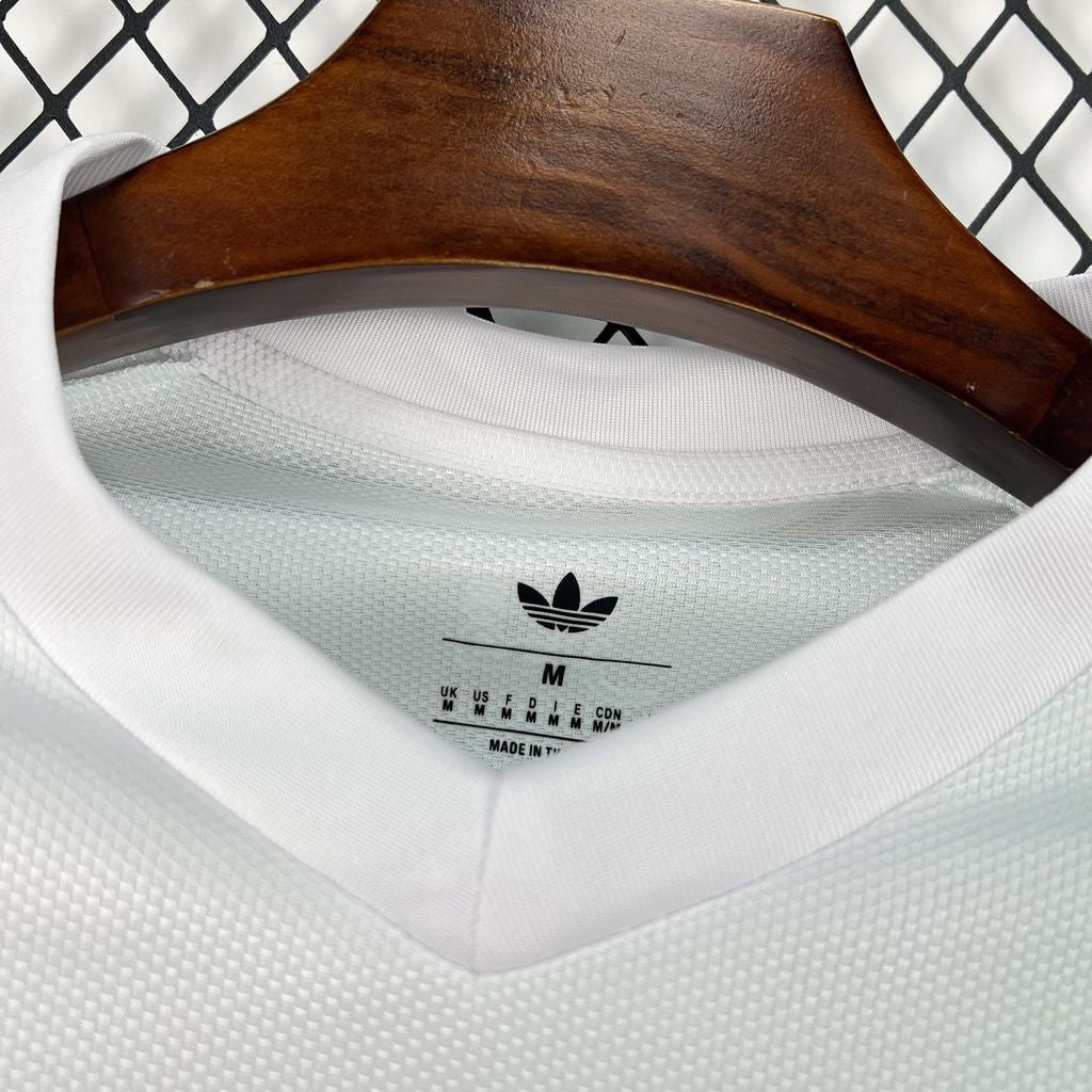 Leazofoot Qatar 2026 away jersey in white with textured fabric and Adidas Trefoil logo on the inner neck label.