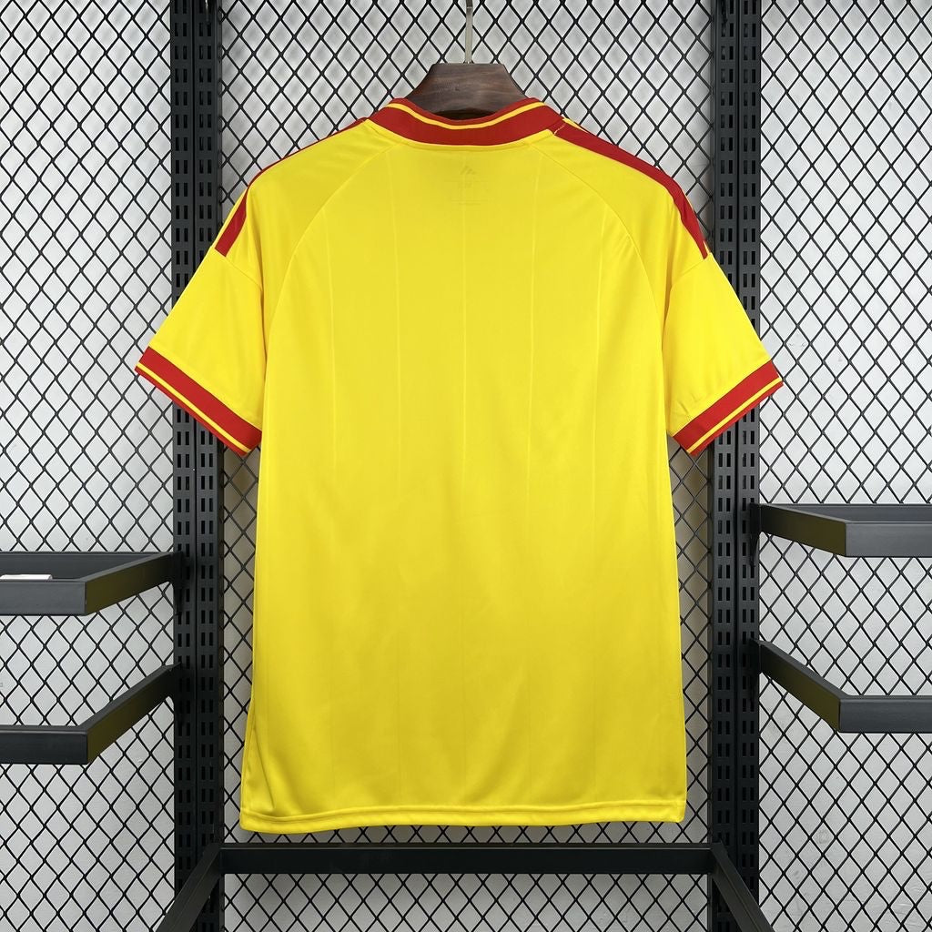 Leazofoot RC Lens 26/27 home football jersey in yellow with red trim on the collar, shoulders, and sleeve cuffs.