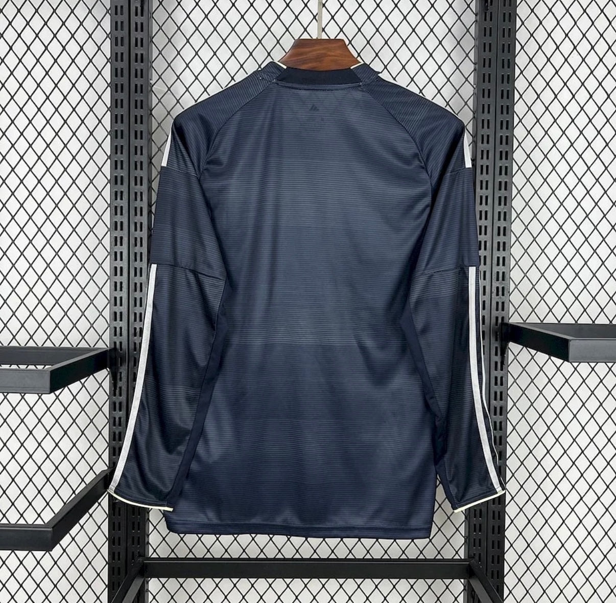 Back view of Leazofoot Real Madrid 25/26 long-sleeve away jersey in dark navy with white side stripe detailing.