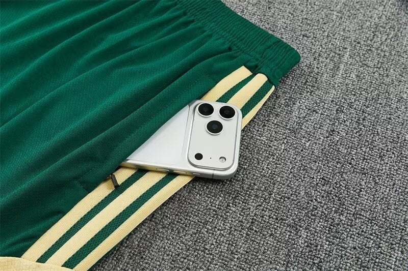 Leazofoot Real Madrid 2026 training shorts in green with yellow side stripes and a zippered pocket