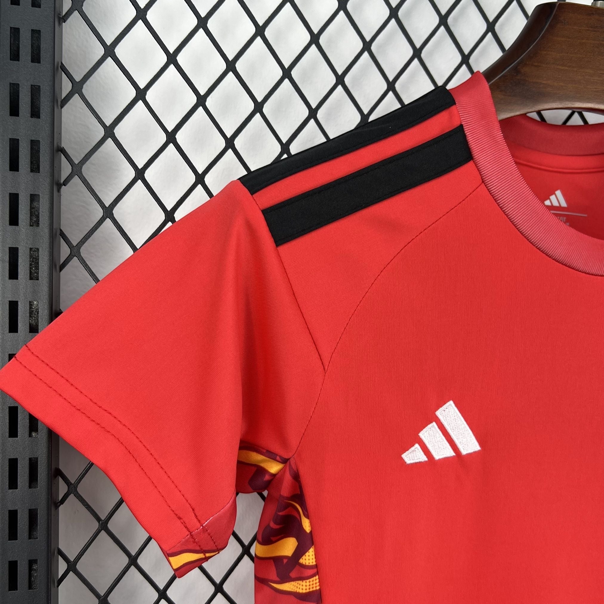Leazofoot red polyester kids' soccer jersey with black stripes on shoulders and white Adidas logo.