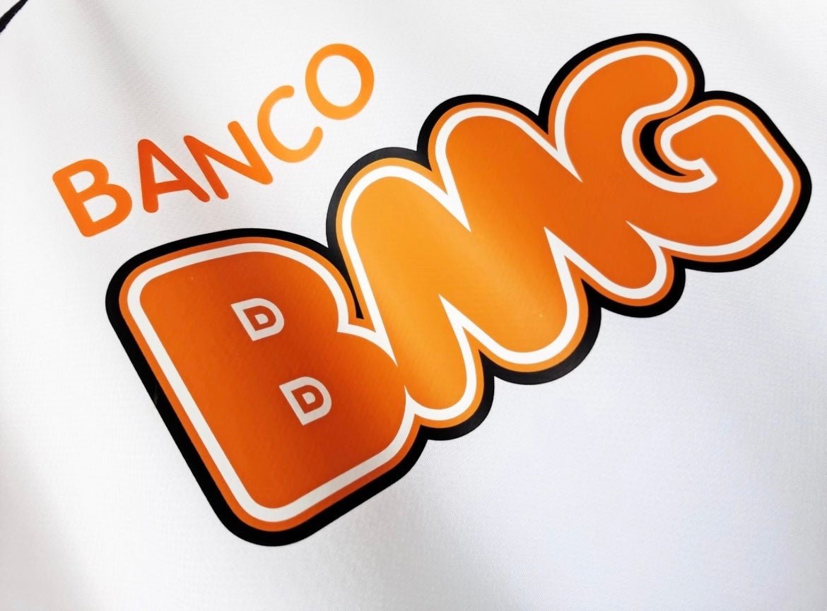 Close-up of the Banco BMG sponsor logo on a white Leazofoot Santos 2012-13 away football jersey.