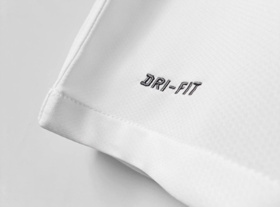 Close-up of white Leazofoot Santos 12/13 away jersey fabric featuring embroidered Dri-Fit technology logo.