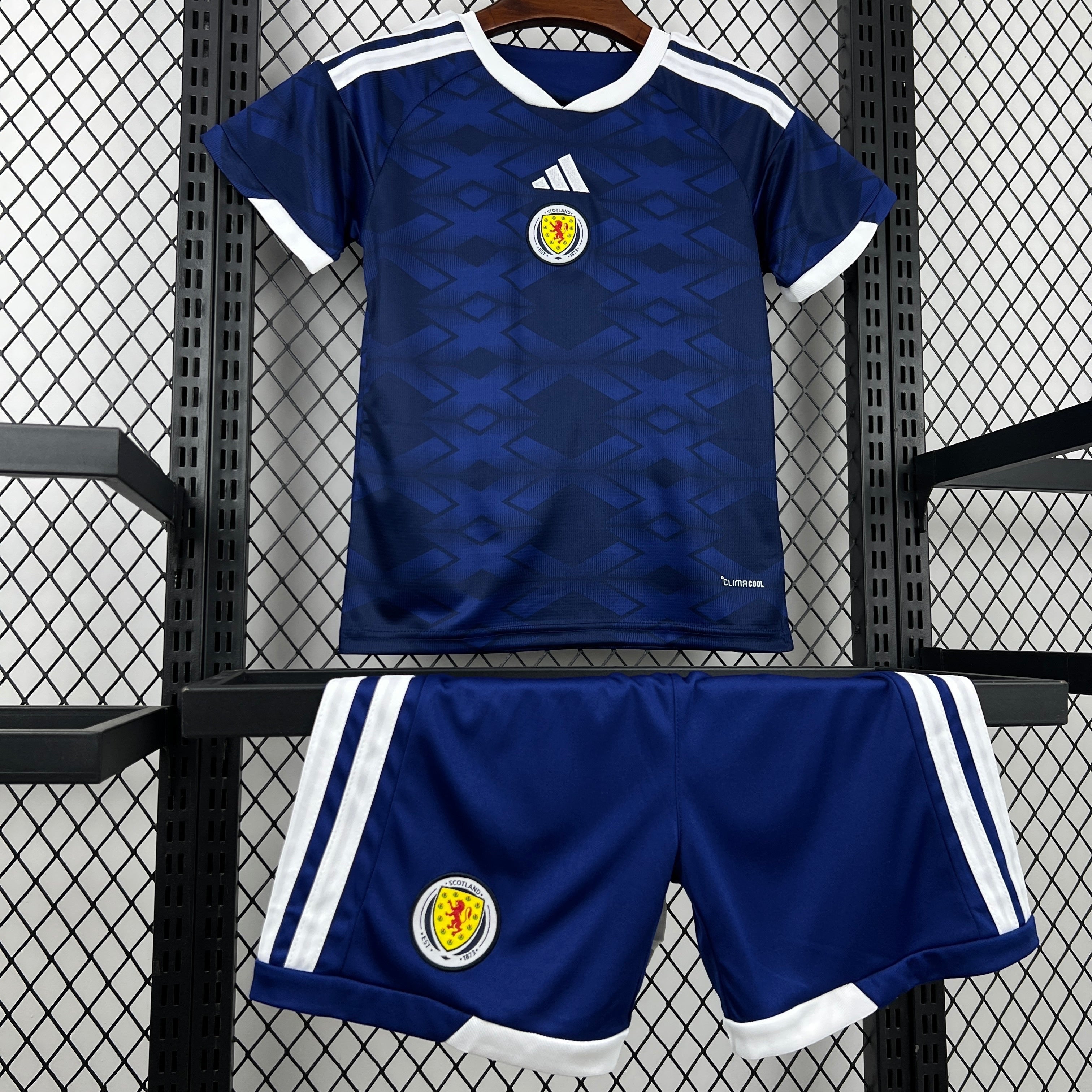 Leazofoot Scotland kids' navy blue soccer jersey and shorts set with white trim and diamond pattern.