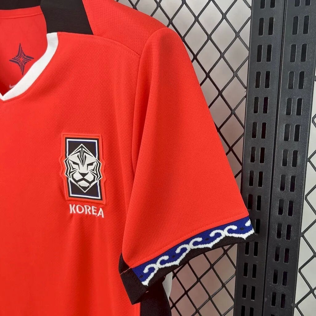 Leazofoot South Korea 2026 home soccer jersey. Red with white and black trim, featuring a lion crest and "KOREA" text.