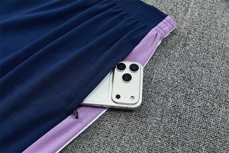 Leazofoot South Korea 2026 training shorts in navy blue with purple side panels and a zippered pocket detail.