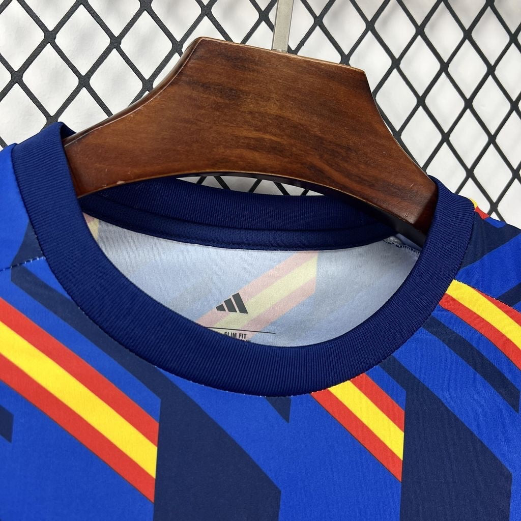Leazofoot Spain 2026 pre-match football jersey with blue, red, and yellow geometric pattern.