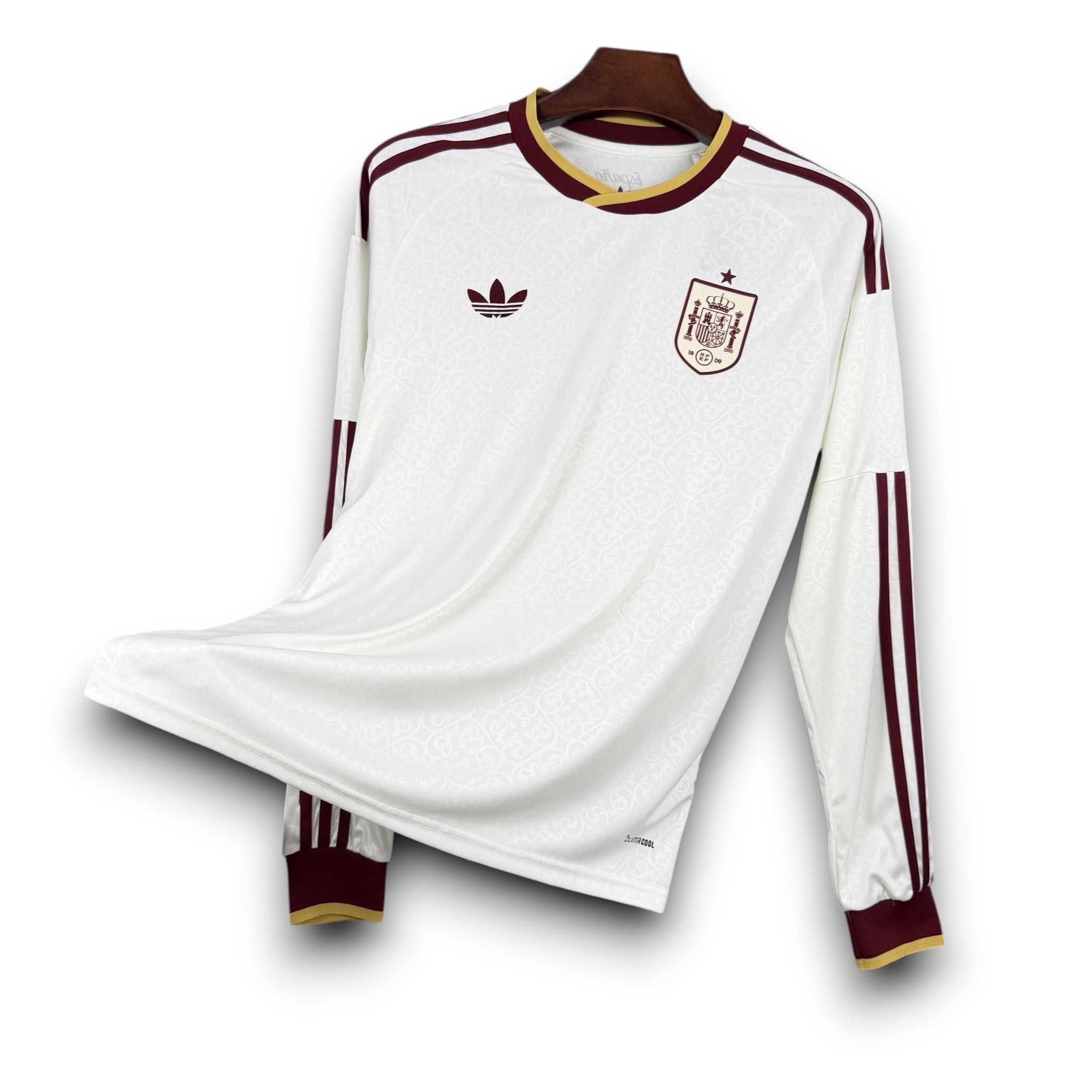 Leazofoot Spain long sleeve away jersey 2026. White with maroon and gold trim. Features Adidas logo and Spain crest.