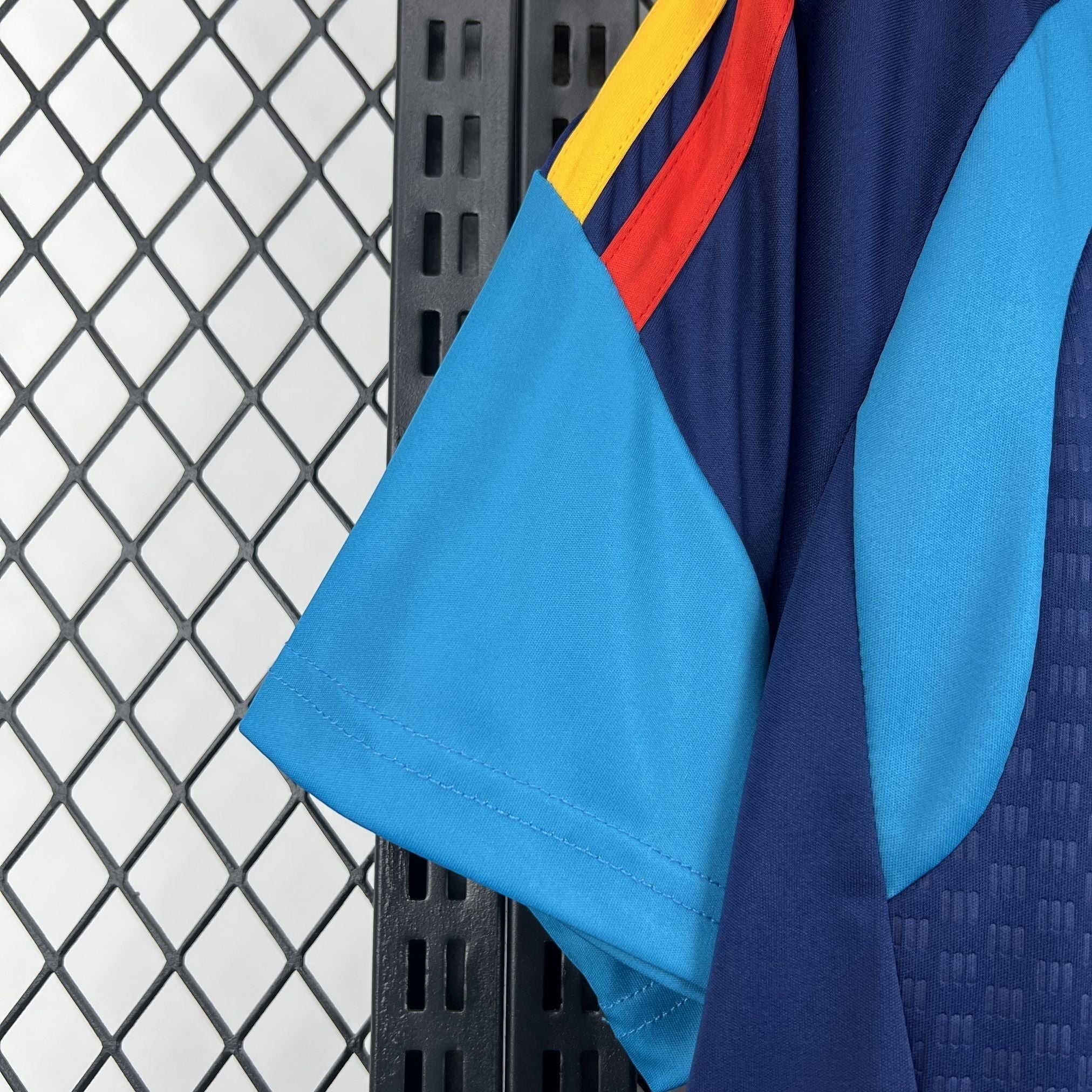 Leazofoot Spain 2026 pre-match jersey with navy blue, light blue, red, and yellow accents.