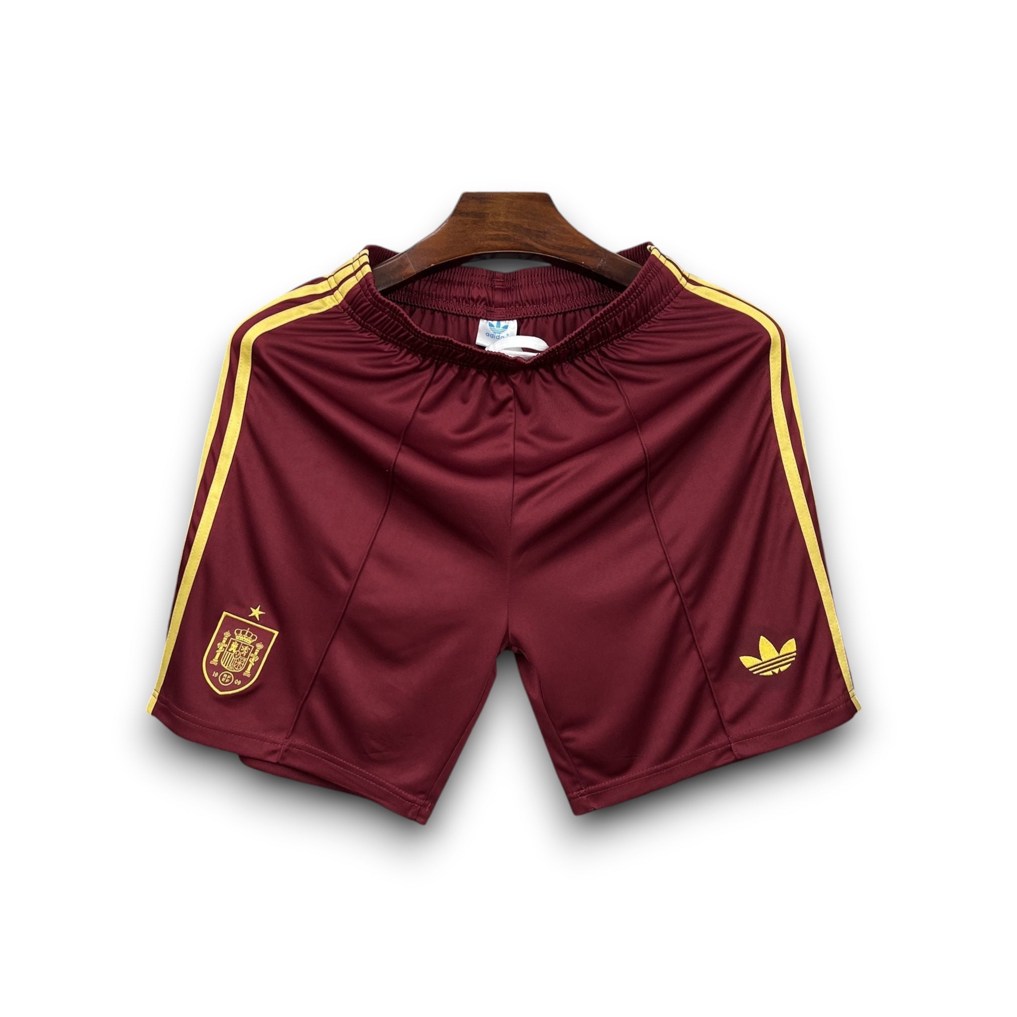 Leazofoot Spain 2026 burgundy soccer shorts with yellow stripes and embroidered crest.