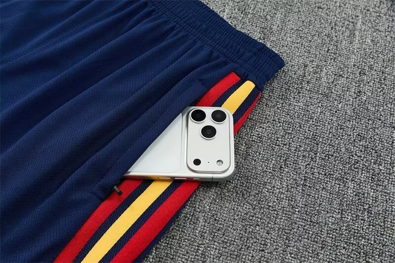 Leazofoot Spain 2026 training shorts in navy blue with red and yellow side stripes and a zippered pocket