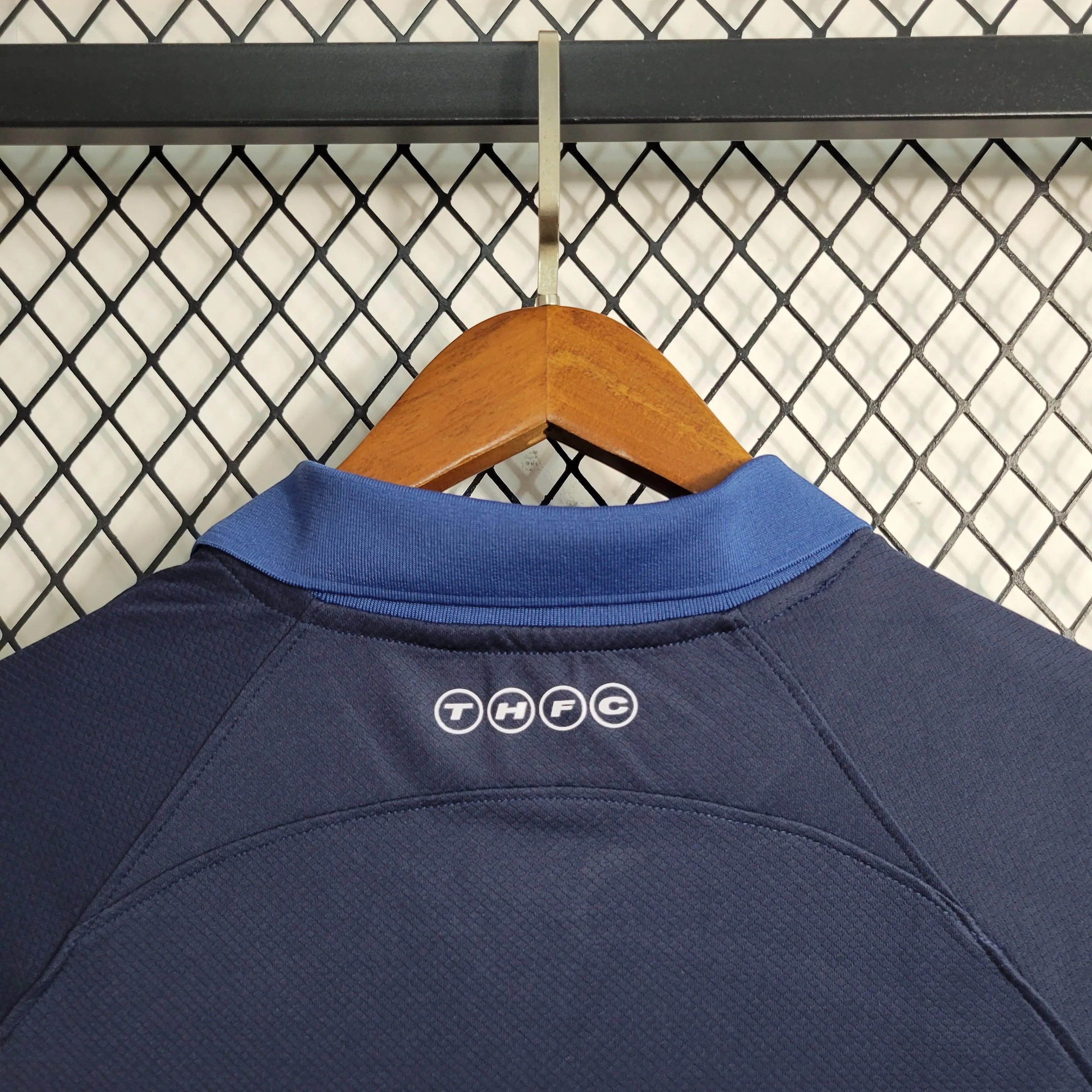 Leazofoot Tottenham 23/24 away jersey, dark blue with blue collar and THFC logo detail on back.