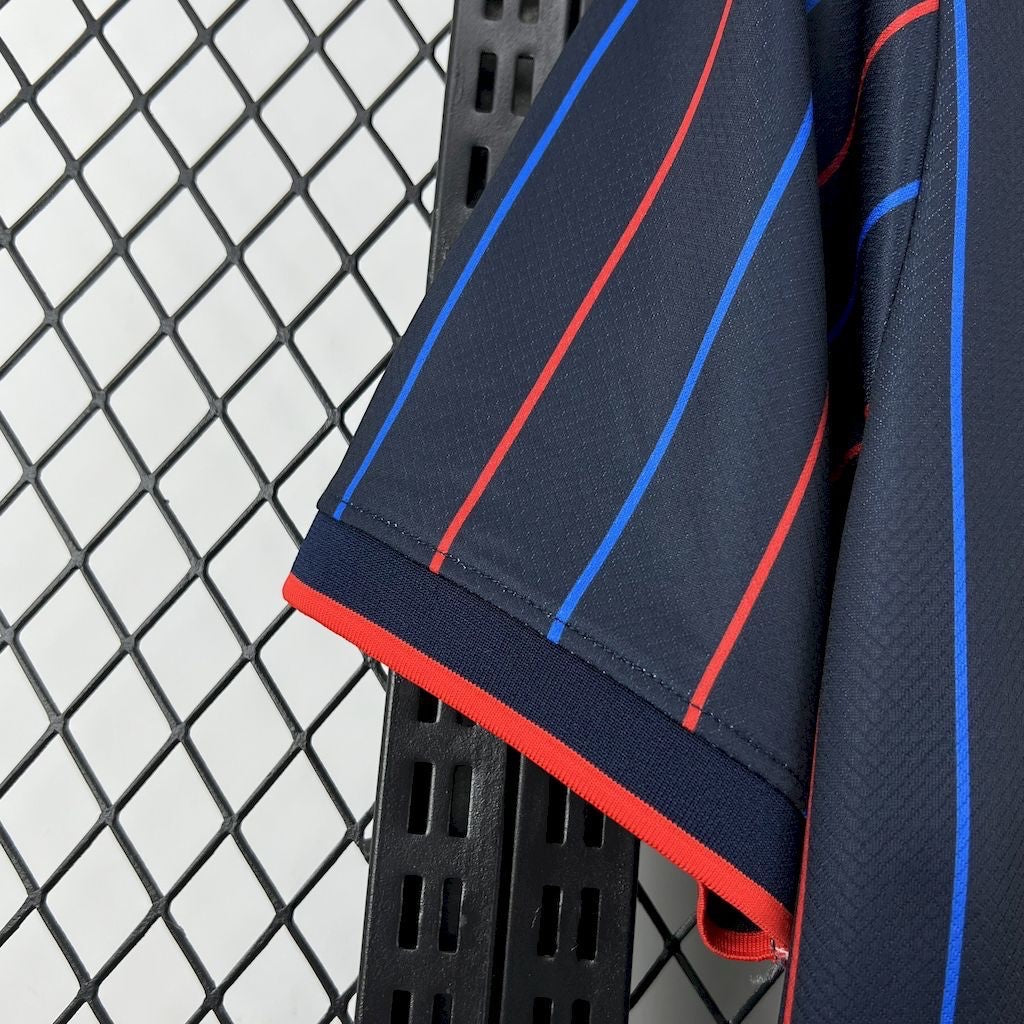 Leazofoot 2025 USA away soccer jersey in navy blue with red and blue vertical stripes and ribbed sleeve cuffs.