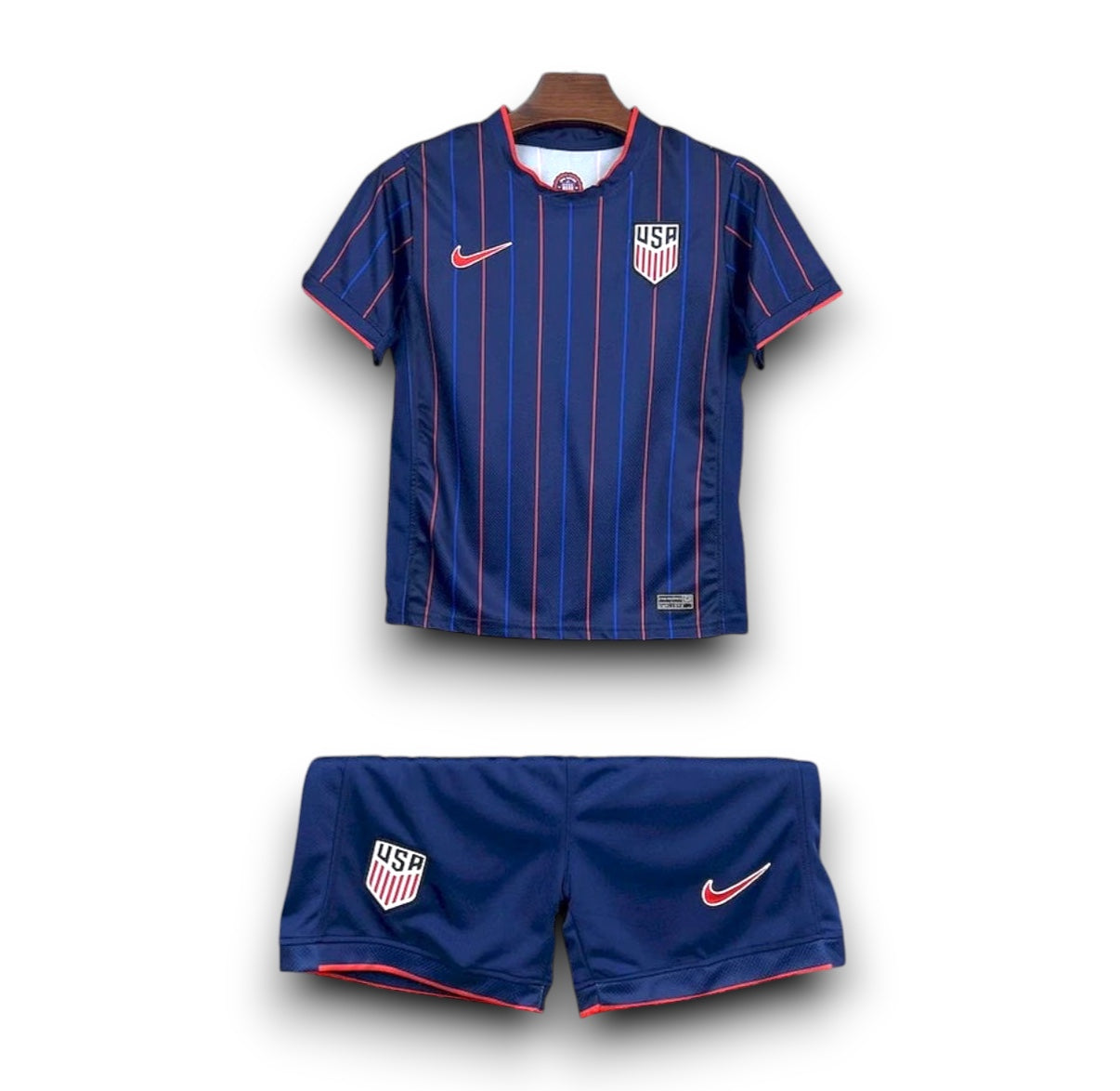 Leazofoot 2025 USA kids away soccer kit in navy blue with red and blue pinstripes and team crest.