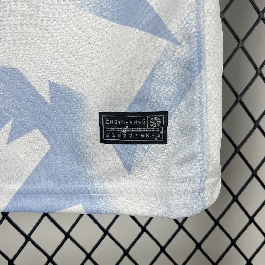 Leazofoot USA 2025 kids home kit jersey detail featuring white and light blue geometric pattern and authenticity tag.