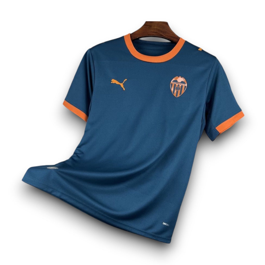 Leazofoot Valencia CF 2026-2027 away jersey in dark blue with orange trim and Puma logo on a hanger