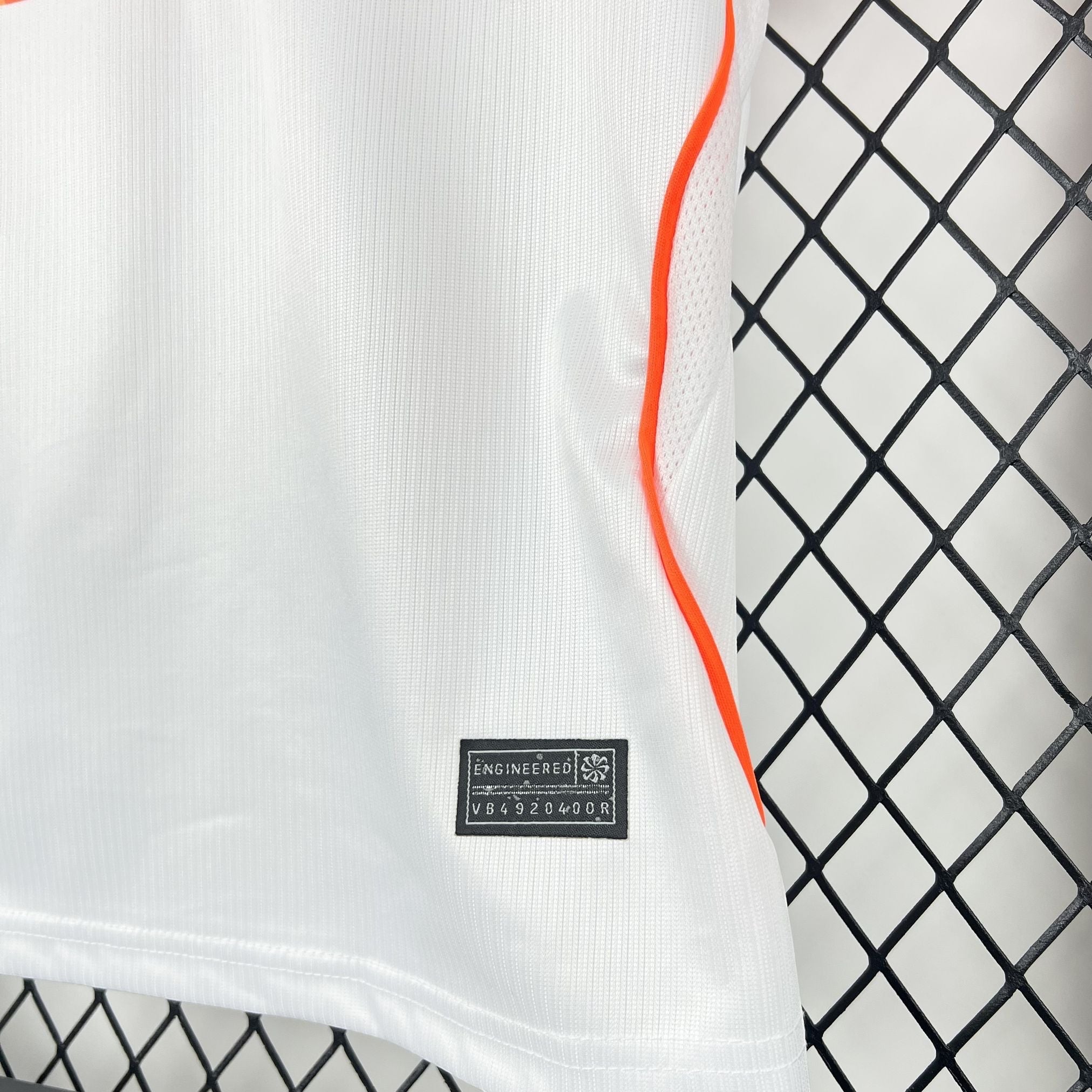 Leazofoot white polyester kids' soccer jersey with orange trim and mesh panels.