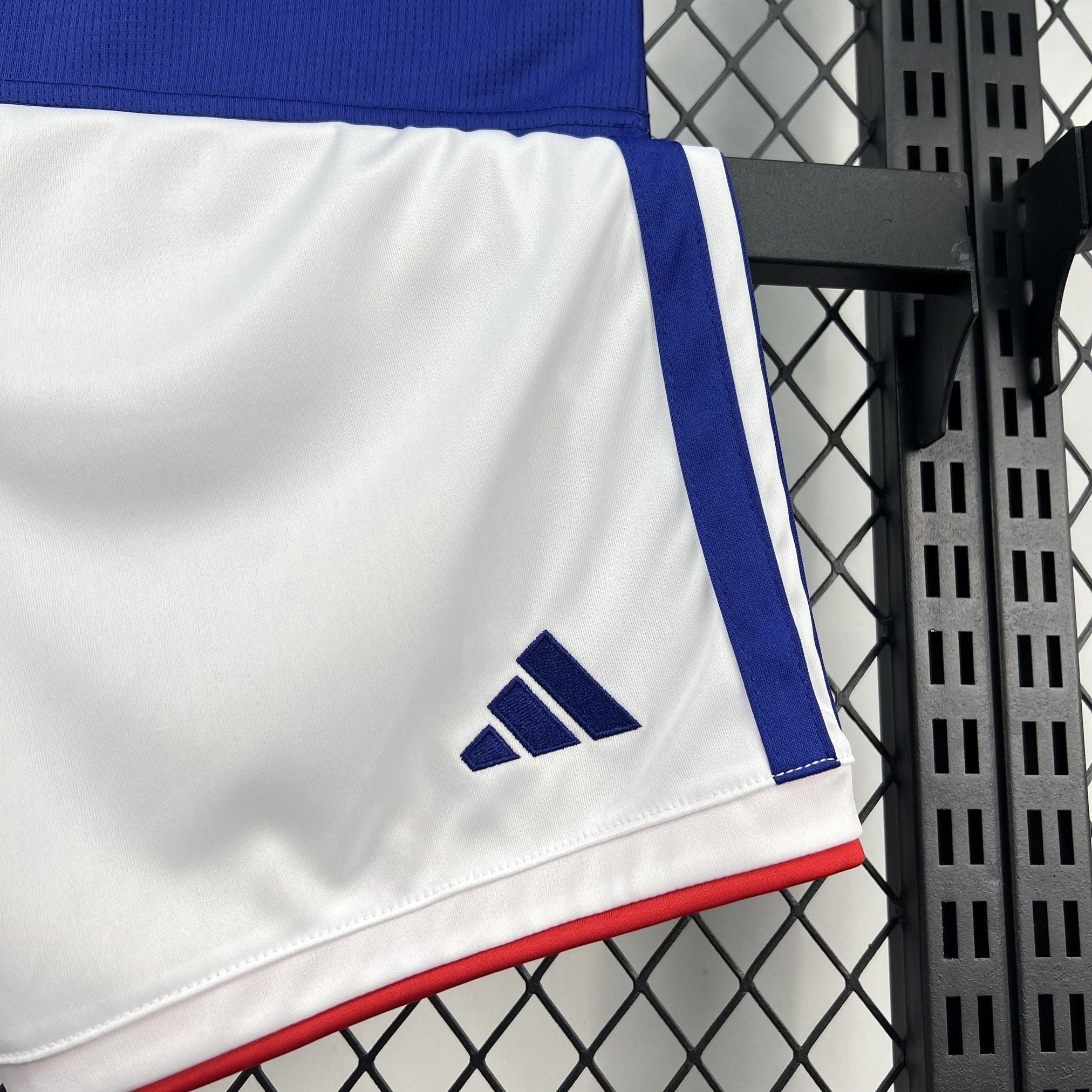 Leazofoot white shorts with blue stripes and red trim, featuring the Adidas logo.